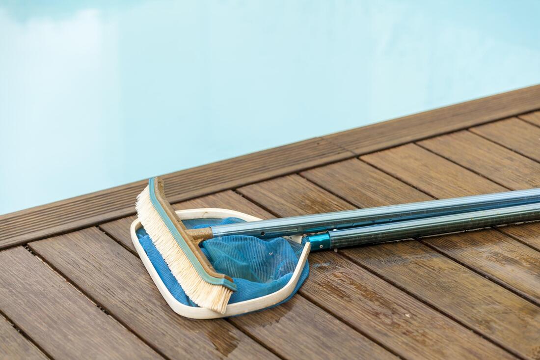 cleaning tool beside the pool